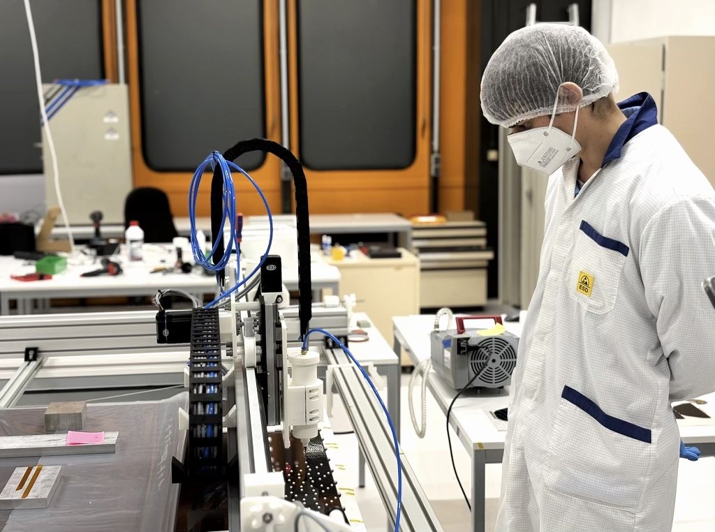 Technician in cleanroom gear at the lay-down line